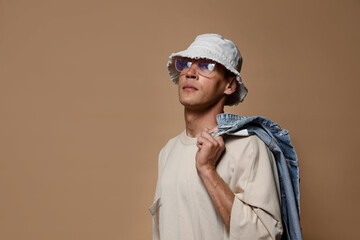 Fashionable portrait of handsome man in stylish outfit on brown background, space for text