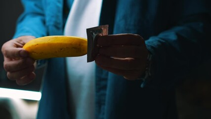 СТОКA man with a banana and a condom shows how to protect himself from unwanted pregnancy and sexually transmitted infections.
Aborted pregnancy.
Safe sex.
Intimacy, pregnancy, abortion, sex