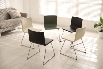 Chairs in circle prepared for group psychotherapy session indoors