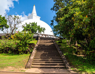 The ancient Buddhist Mihintale staircase leading up to a sacred white stupa