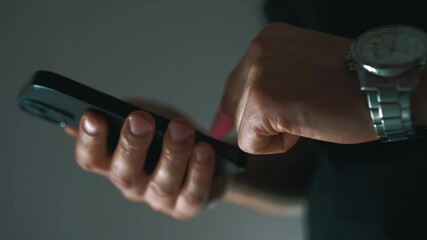 An adult businessman uses a mobile phone.
Phone in hands close-up.
A businessman is typing text on a smartphone.
Email on phone