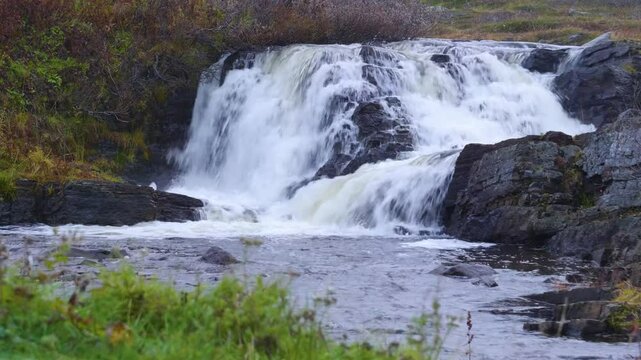 Footage presents Kivach Waterfall, a 10.7-meter-high cascade on the Suna River in the Republic of Karelia, Russia, known for its historical significance and natural beauty.
