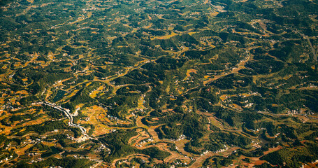 View From Airplane Window On Surroundings Of Chengdu, China. Mountainous Wooded Terrain Landscape Of China. Porthole View Or Called Bull's-eye Window. Private Buildings. Discover China