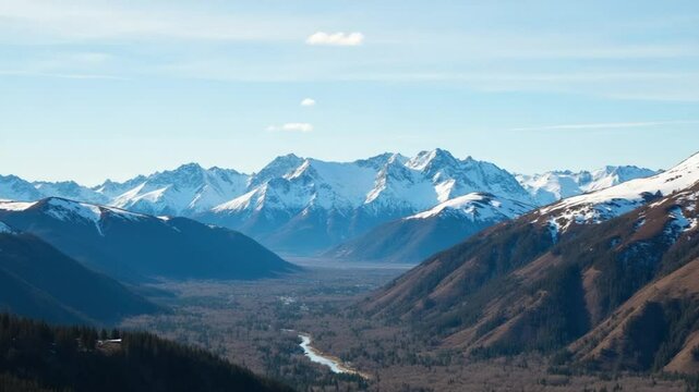 Aerial Over Valley With Snow Capped Mountains In Distance