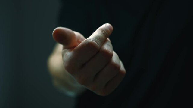A man is doing arm stretching in a dark room.
Hand motor skills.
Brush movement.
Exercises for a good wash of hands after a stroke.
Coordination of movements.
Hand gesture