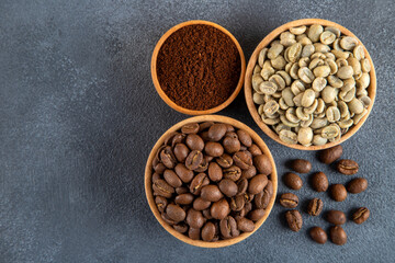 Green coffee with roasted coffee beans on black background