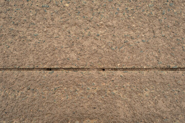 A close up of a brick wall with a line of holes in it