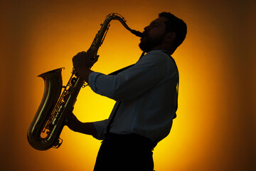 Professional musician playing saxophone on color background, backlit