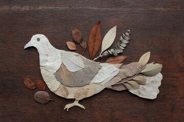 A decorative bird design crafted from dried leaves.