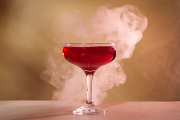 Red alcoholic cocktail on beige background. Alcoholic drink
