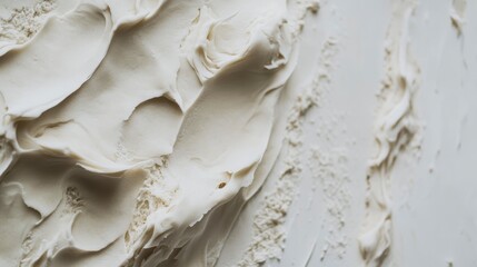 Close-up of creamy, textured white substance with swirls and streaks.