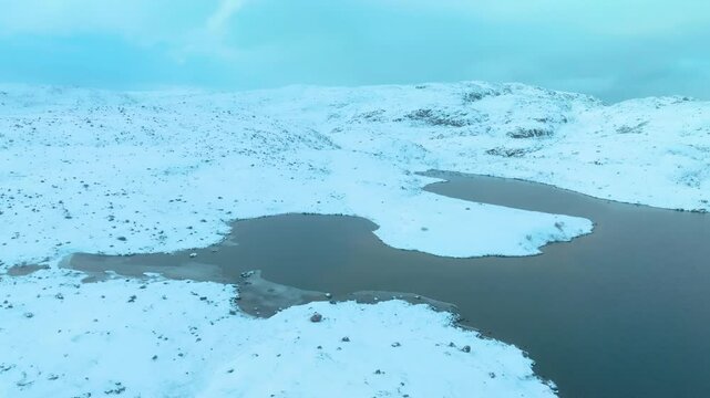 Aerial view of a large glacier at Musta - Tunturi Ridge, featuring slowly shifting ice sheets formed over long periods in Arctic Russia.