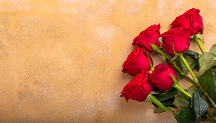 Vibrant bouquet of red roses placed against a textured gold background, symbolizing love, romance, and celebration.