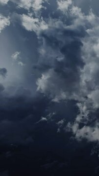 Lot of lightning during a thunderstorm. Storm clouds are moving fast on the viewer, timelapse. Vertical video