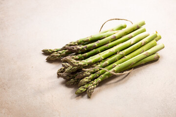 Fresh green asparagus on stone surface healthy food