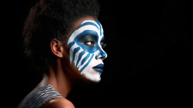 Afrocentric face paint on woman in profile view