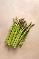 Overhead view of Fresh green asparagus on stone surface