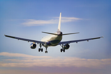 Departing view of an approaching passenger airplane preparing to land at the airport.