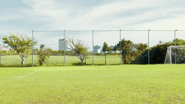 Kid, running and soccer practice on field with parachute, strength training and fitness exercise. Active child, equipment and sport workout for endurance, speed challenge and cardio routine of league