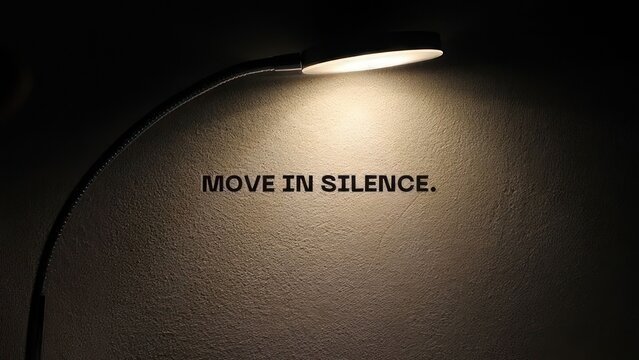 move in silence motivational quote spotlight illuminated wall text