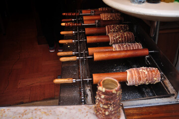 Local czech bread called Trdelnik rolled dough then grilled topped with sugar and walnut mix for sale czechia people and foreign travelers in Old Town Square at Praha city in Prague, Czech Republic