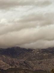 Low clouds covering the mountain peaks on a cloudy day