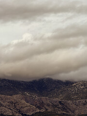 Low clouds covering the top of mountains in a cloudy day