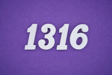 The numbers are made of white painted wood placed on a purple paper background.