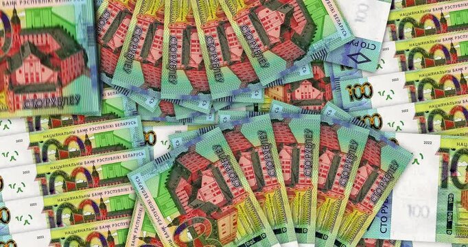 Belarus money Belarusian rubel banknotes in a cash fan mosaic pattern loop. 100 BYN notes. Abstract concept of bank, finance, economy seamless and looped design background.