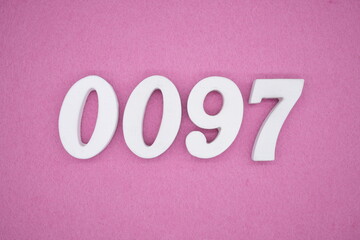 The numbers are made of white painted wood, placed on a pink paper background.