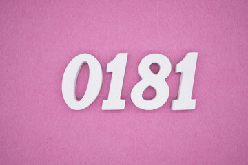 The numbers are made of white painted wood, placed on a pink paper background.