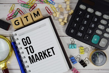 GTM - Go to Market acronym on notepad, Business and Financial concept background