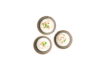 Top View of Three Bowls of Indian Dahi Vada Garnished with Spices and Herbs on PNG Background