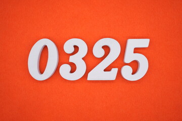 The numbers are made of white painted wood placed on an orange paper background.