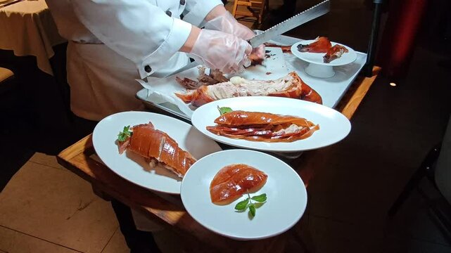 Slicing succulent roast Peking duck in Shanghai's vibrant culinary scene at dinner event. 