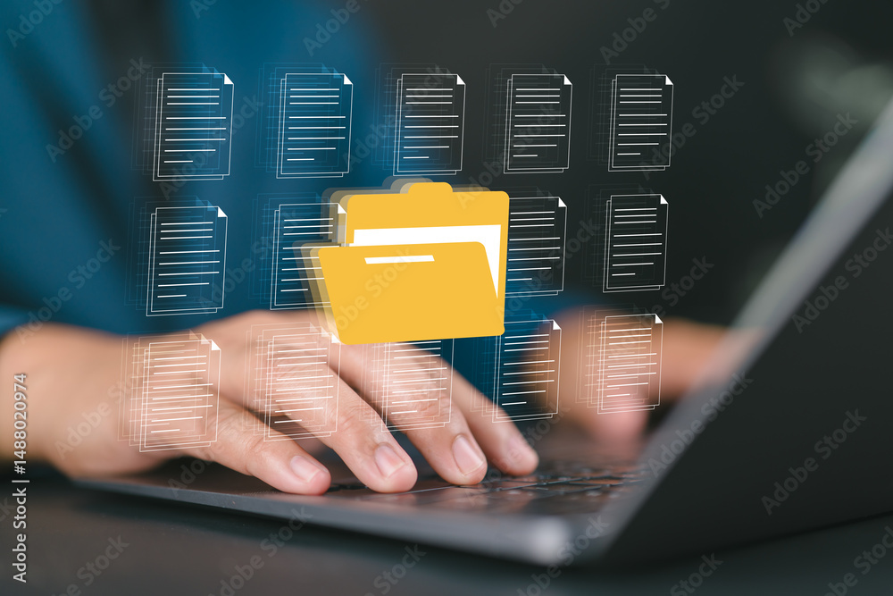 Fototapete businessman managing digital documents and folders on laptop with hologram interface, symbolizing da