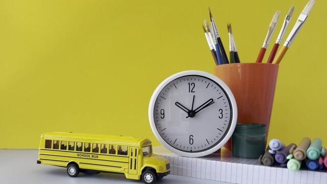 Creative School Supplies on Yellow Background Colorful School Bus and Art Supplies on Table