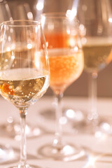 A close-up of glasses with alcoholic beverages. Cups with colorful sparkling wines from different grape varieties