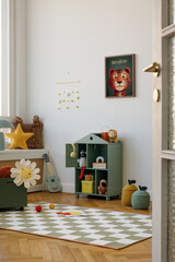 Bright and colorful playroom with wooden toys, books, and a tiger mock up poster frame above a desk. A creative and fun space for children. Home decor.
