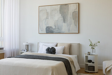 Modern bedroom scene with a knot pillow, monochrome bedding, and light-filled atmosphere, styled with minimal decor elements.