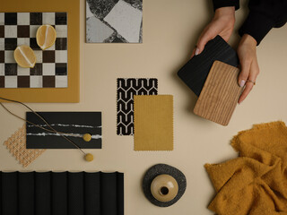 A mustard yellow and black contrast mood board with geometric patterns, wood samples, and natural...