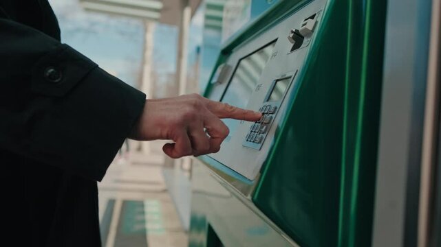 Person Using Ticket Vending Machine, male hand 