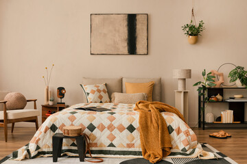 Warm and cozy bedroom interior with mock up poster frame, beige and orange bedding, patterned rug,...