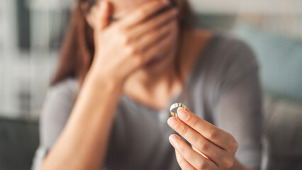 Woman taking off her wedding ring
