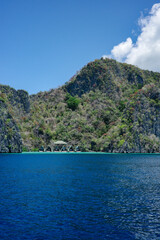 Fototapeta premium A private and luxury resort hideaway in the middle of Coron, Palawan islands. Face the wide ocean and has a beautiful mountain range in the background. The most perfect summer holiday in Asia
