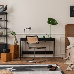 Creative composition of room interior with mock up poster frame, black desk, cozy bed, rattan chair, patterned rug, wooden bench, stylish lamp, rack and personal accessories. Home decor. Template.