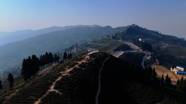Aerial view of a green tea garden in ilam, Nepal. Fresh Green tea Field. Green tea plantation and forest nature landscape. Beautiful mountain tea garden landscape.
