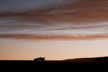 racing car silhouette against stunning sunset backdrop essence of speed and power
