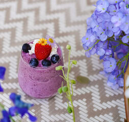 Berry Yogurt Smoothy. A closed up Top view of berry yogurt milkshake including starberry and blueberries on top. Diet and healthy drink. Summer refreshment.
