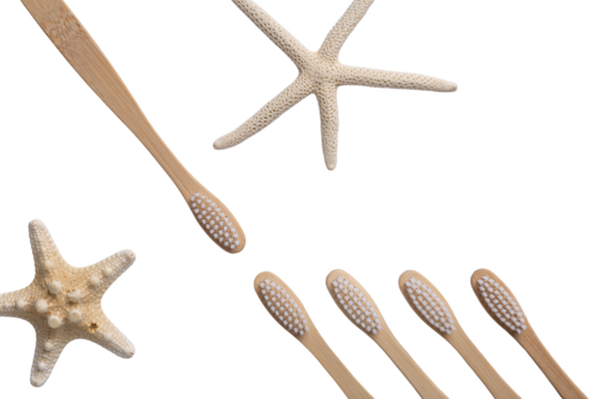 A set of eco-friendly bamboo wooden toothbrushes with starfish on a white towel.